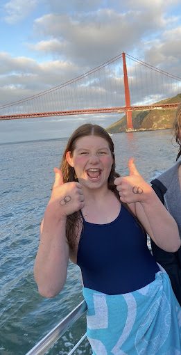 Sophie Dumanski poses in front of the Golden Gate Bridge after swimming its length. Accomplishing this goal helped raise money for the Neptune Swimming Foundation and water safety. 