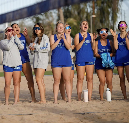 The varsity Gators cheer on Summer McCann ‘23 and Vivian Hickman ‘26 during doubles on senior night. Xavier beat Chandler 5-0. 