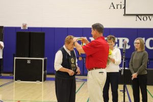 Sister Lynn Winsor receives her award into the National Federation of State High School Associations Hall of Fame on September 8, 2023 during Xavier’s first all-school rally. David Hines, executive director of the AIA, gave Winsor her medal. 