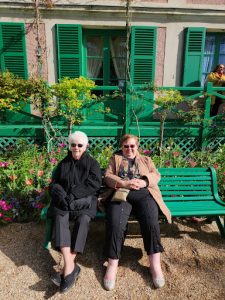 While at the house outside of Monet’s garden in Giverny, France on April 13, 2023, Sister Joan Fitzgerald sits next to Sister Joanie Nuckols. The significance of this bench holds great memories of the two sitting together while waiting for Xavier students and families to embrace the beauty of Monet’s garden. (Photo courtesy of Brian Mostoller)