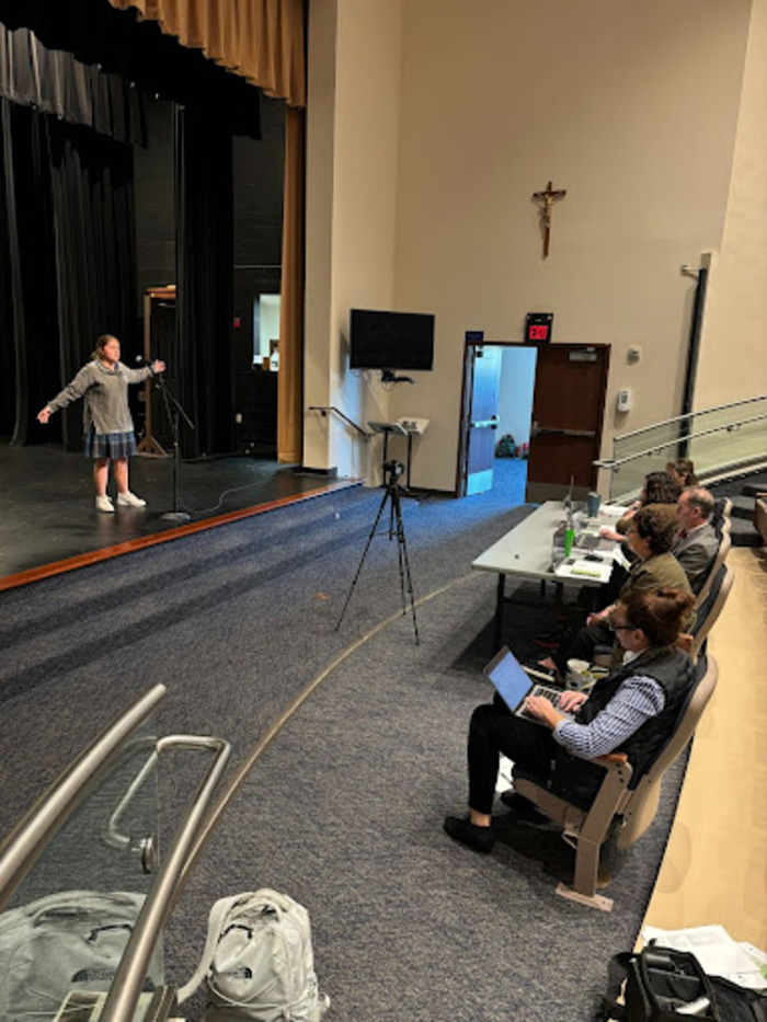 In Xavier’s Grubb Lecture hall, Soledad Tumialán ‘27 gives a passionate performance of her selected poem. In preparation for the contest, participants memorized two poems and chose one to deliver to the judges in the Xavier-wide competition.