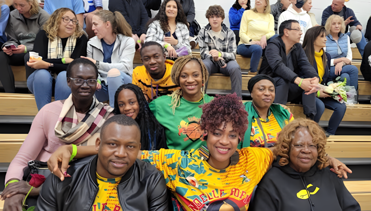 Suzy (front row middle) and Beatrice Bofia (second row, third from left) pose with family and friends to cheer on the Gators. Many wear the famous t-shirt showing Noelle’s face. (Photo courtesy Suzy Bofia)