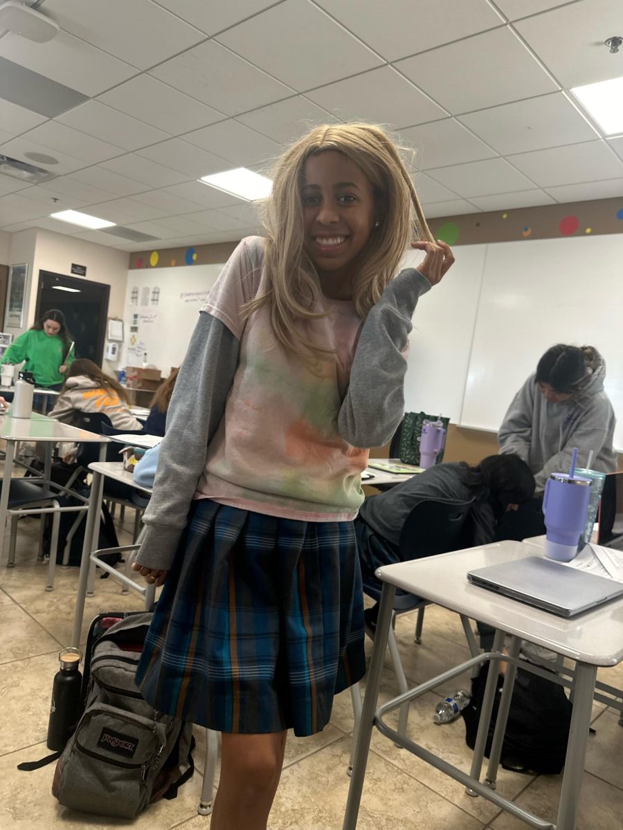 Sophomore Brooke Gillespie poses in her blond wig for Catholic schools week Wacky Wednesday. Students were encouraged to come in their wackiest attire. 
