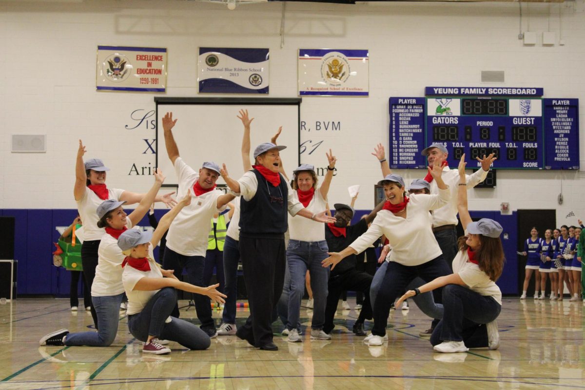 Sister Lynn Winsor, one of the BVM sisters, dances in the center of other faculty members of Xavier. The faculty dance was performed in front of the Xavier students during a school rally.