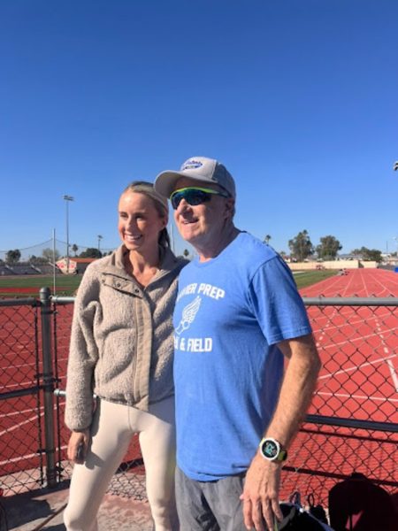 Jessica McClain smiles with Xavier assistant cross country and track coach Vito Perrone. McClain visited the Brophy track on February 14 to speak with current runners following her Olympic Trials success.