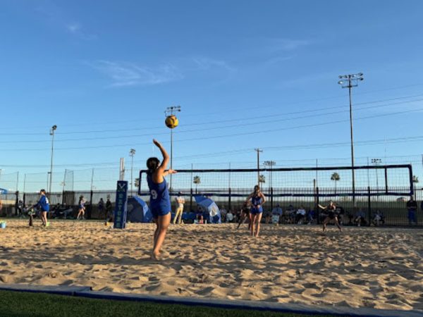Trinity Tran ‘24 serves the ball while her partner Kate McDonald ‘25 focuses on Casteel players. Tran and McDonald played in the 1s and won this match with an overall score of 21-10 and 21-12. 