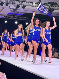 Xavier students walk the runway representing cross country at the parade of activities in last years fashion show. The parade of activities is when seniors show off the clubs, sports and activities at Xavier in uniforms.