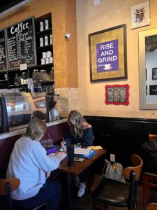 Rowan Ostendorf ‘25 and Maggie Henry ‘25 prepare for their upcoming math test with a study session at Hava Java. Both students are enjoying Hava Java’s famous Frozen Javas. 