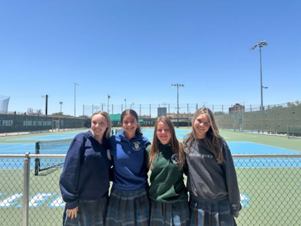 Xavier Gators pose in front of the tennis courts on Wednesday following their victory. The teammates celebrate a new championship and are excited for the future of their program.