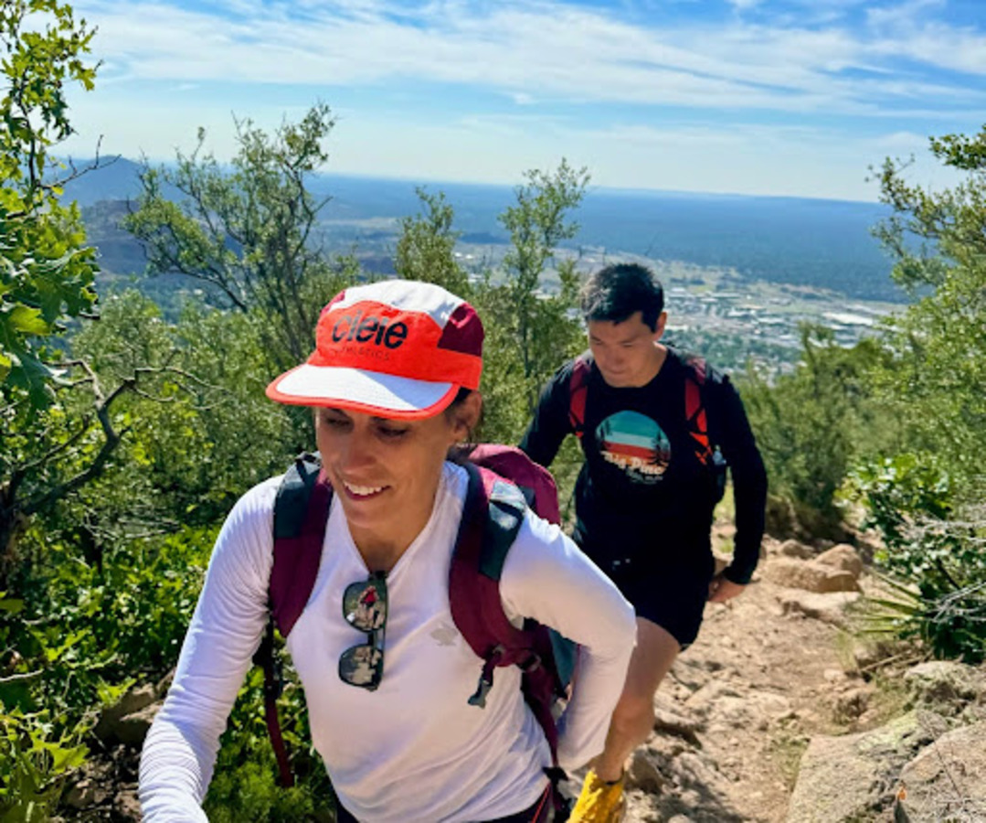 Co-coaches Nissa Kubly and Daniel Wong stride up Mt. Elden during summer training camp in Flagstaff, AZ. These coaches demonstrate servant leadership by working out with their team.