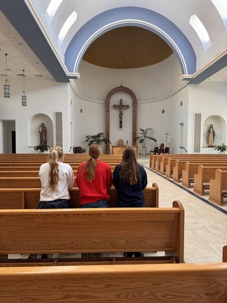 Three Xavier students await Mass in the Chapel of our Lady during lunch on Monday. Although the Mass was canceled, the girls reflect quietly and set new intentions for the week. 