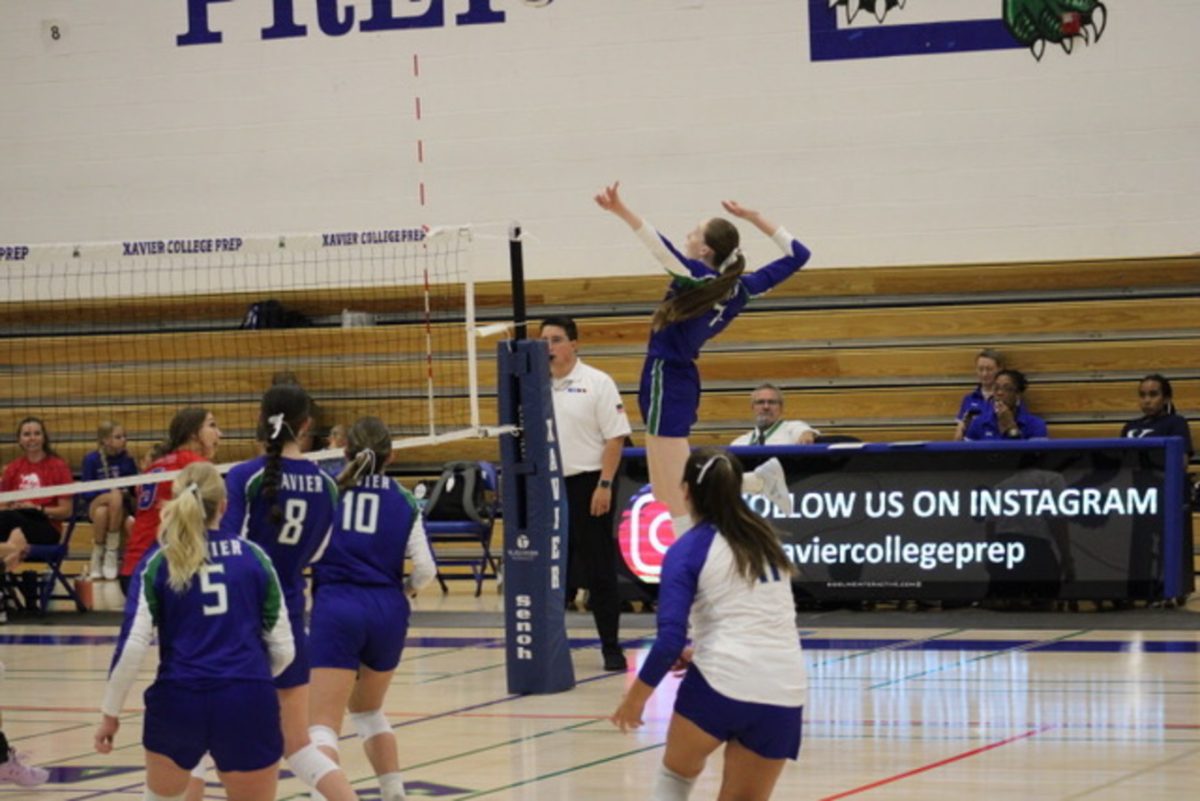 Xavier’s varsity volleyball team plays an intense game against Mountain View. Soon-to-be-Torero, Allison Dunnion’26, jumps to hit the ball to the opposition.