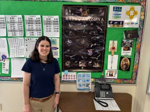 Sarah Schimpp poses proudly in front of her “Bats of Arizona” poster. Schimpp did her master’s project on the differences between bat species in urban and rural areas.