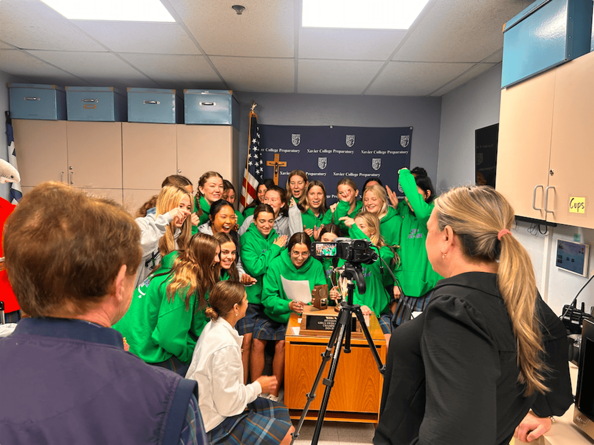 Xavier swim and dive celebrates its state win by displaying its trophy on Xavier’s morning announcements. The Gators took first place in three events, winning the overall competition with a score of 398.