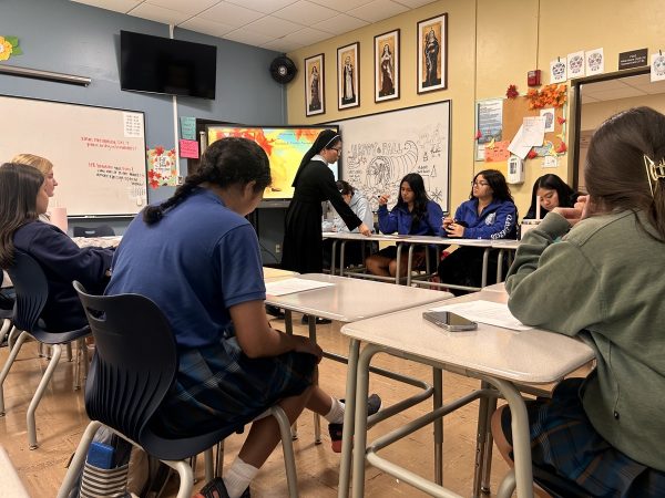 Students in the sacrament prep program sit attentively after school during their fourth session, which was focused on the Eucharist, the ritual of the Mass and adoration. These sessions will continue until April, when the students receive their sacraments.  