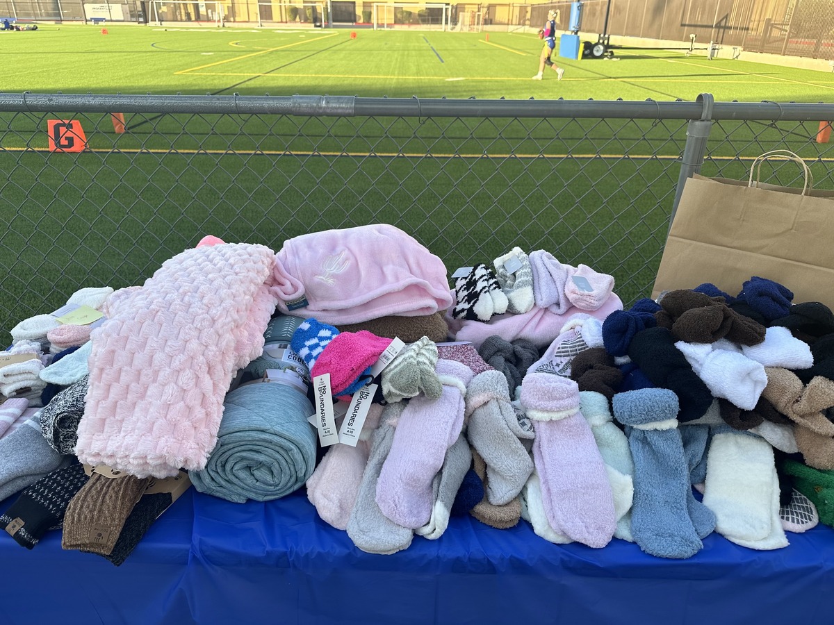 Fuzzy socks are donated by Xavier’s flag football team in front of Petznick Field before the team’s game against Desert Vista High School. The flag football team partnered with Maggie’s Place to provide sock donations to mothers in need.