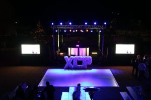 The dance floor and main stage of the event are viewed from upstairs VPC. It is surrounded by tables where guests socialize before the auction begins.