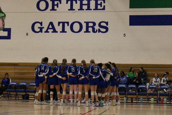 The varsity volleyball team huddles up wearing its “baggy blues” before it plays its last match of the regular season against Millennium. The Gators are ranked No. 1 in the state and are determined to dominate heading into the playoffs. 