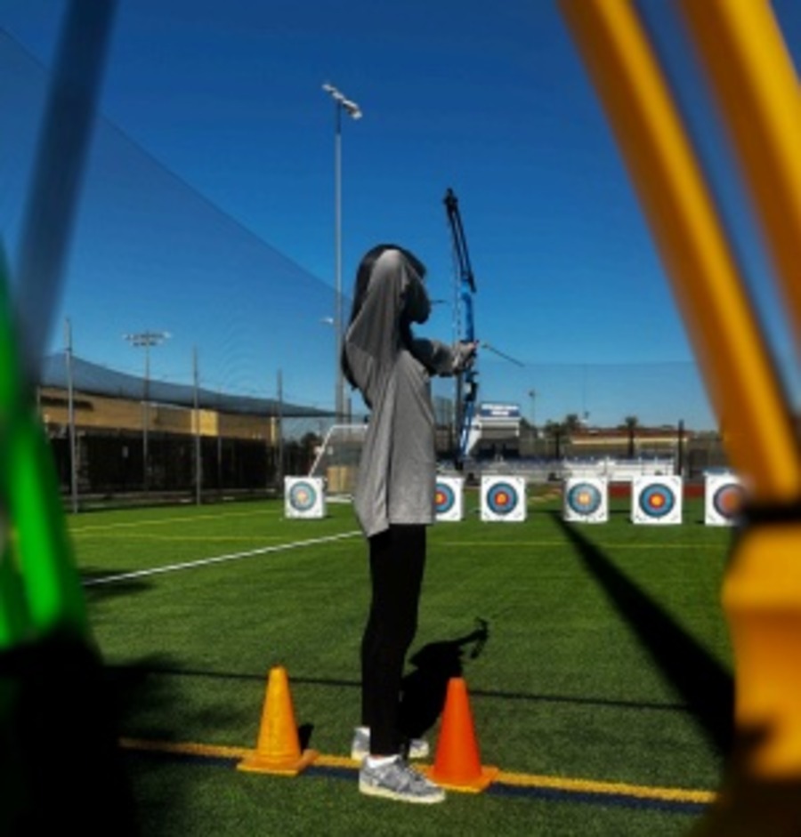 Freshman Thalia Wilcox looses an arrow with precision at morning archery training on Petznick Field. She has previously won third place among ninth grade girls in both the Wickenburg and Chino Valley tournaments.