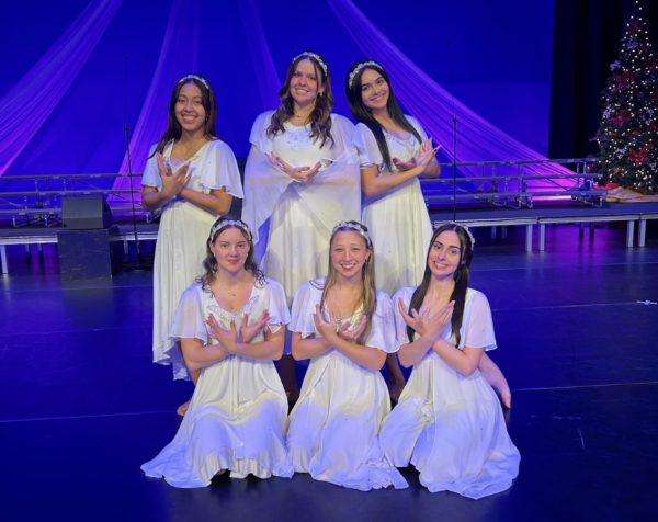 Some of the performance dancers who are portraying angels pose on stage. From left to right, top row to bottom are Tatiana Ceballos Jaimes, Gabriela Gaona, Emily Ortiz, Gianna Roosevelt, Taylor Williamson and Carina Ferrigno.