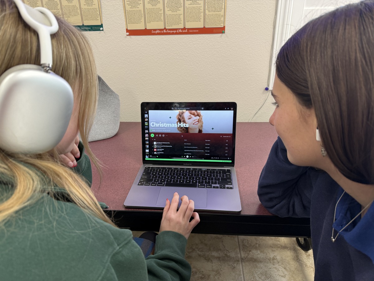 Ryan Young, Faith in Action Editor, and Ellie Hilsabeck, Sports Editor, browse through Spotify’s recommended “Christmas Hits” for this holiday season. 