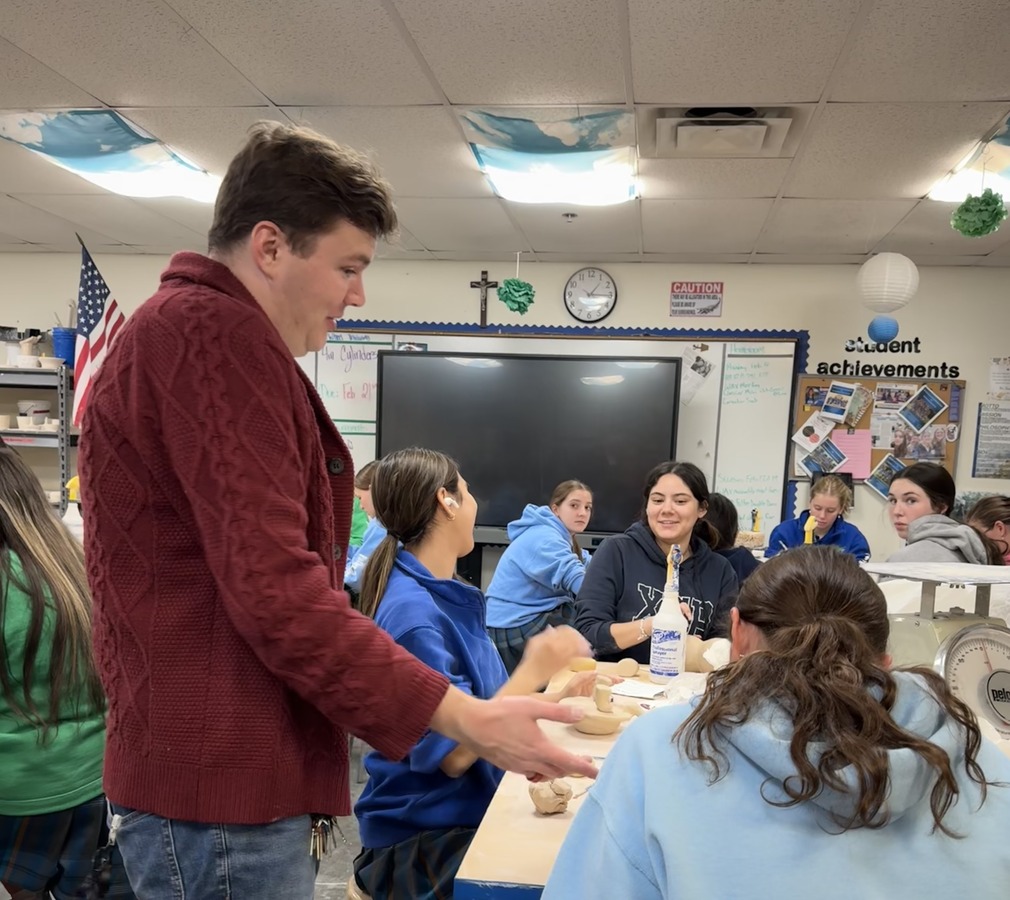 Zach Carlson offers advice to his students in 6th period Beginning Ceramics. They are currently working on the Kiln Buddy project. 