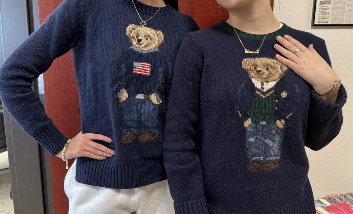 Charley Fisher, editor-in-chief, and Ellie Hilsabeck, sports editor, pose in their matching Ralph Lauren bear sweaters on Country Club or Country Day during Catholic Schools Week. 