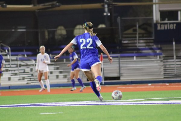 Varsity soccer member Nev Herzog passes the ball to a teammate at a Xavier home game. On Thursday, February 13 Xavier beat Liberty, 3-0, in round 2 of the playoffs, and round 3 is Tuesday, February 18. 