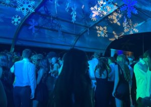 Xavier and Brophy students sing under the snow to music played by a DJ. Brophy hosts all annual school dances such as the back-to-school dance, homecoming, hoopcoming and prom.