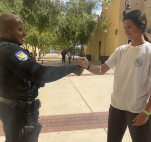 Officer Rey Benson and Emery O’Connor '29 practice a handshake outside of Founders Hall. The interaction reflects the officers’ efforts to build familiarity and connection with the campus community.