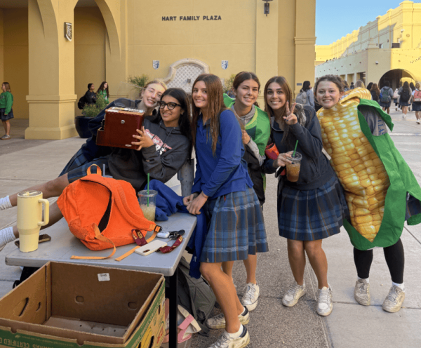 Junior National Honors Society (NHS) members pose while collecting canned goods and monetary donations for Xavier’s annual food drive. All contributions support St. Vincent de Paul and their efforts to serve families in need.