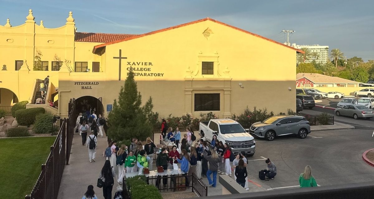 Xavier students participate in “Can Your Skirt Day” by donating many cans to the canned food drive. Volunteering NHS members provide QR codes for students to track how many cans were donated in order to total up the amount for homerooms and for grade levels.