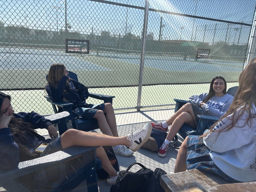 Meghan Nation, Hudson Brodt, Kiera Reckling and Kiana Weiland sit by the tennis courts during lunch. They are chatting about weekend plans and why girl code is important. 