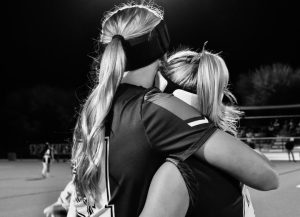 Gigi Bulkley ‘26 and Lucy Coover ‘29 hug on the sidelines of their flag football game. This is the last home game, and Bulkley’s last season, and the team has shown togetherness throughout the season.