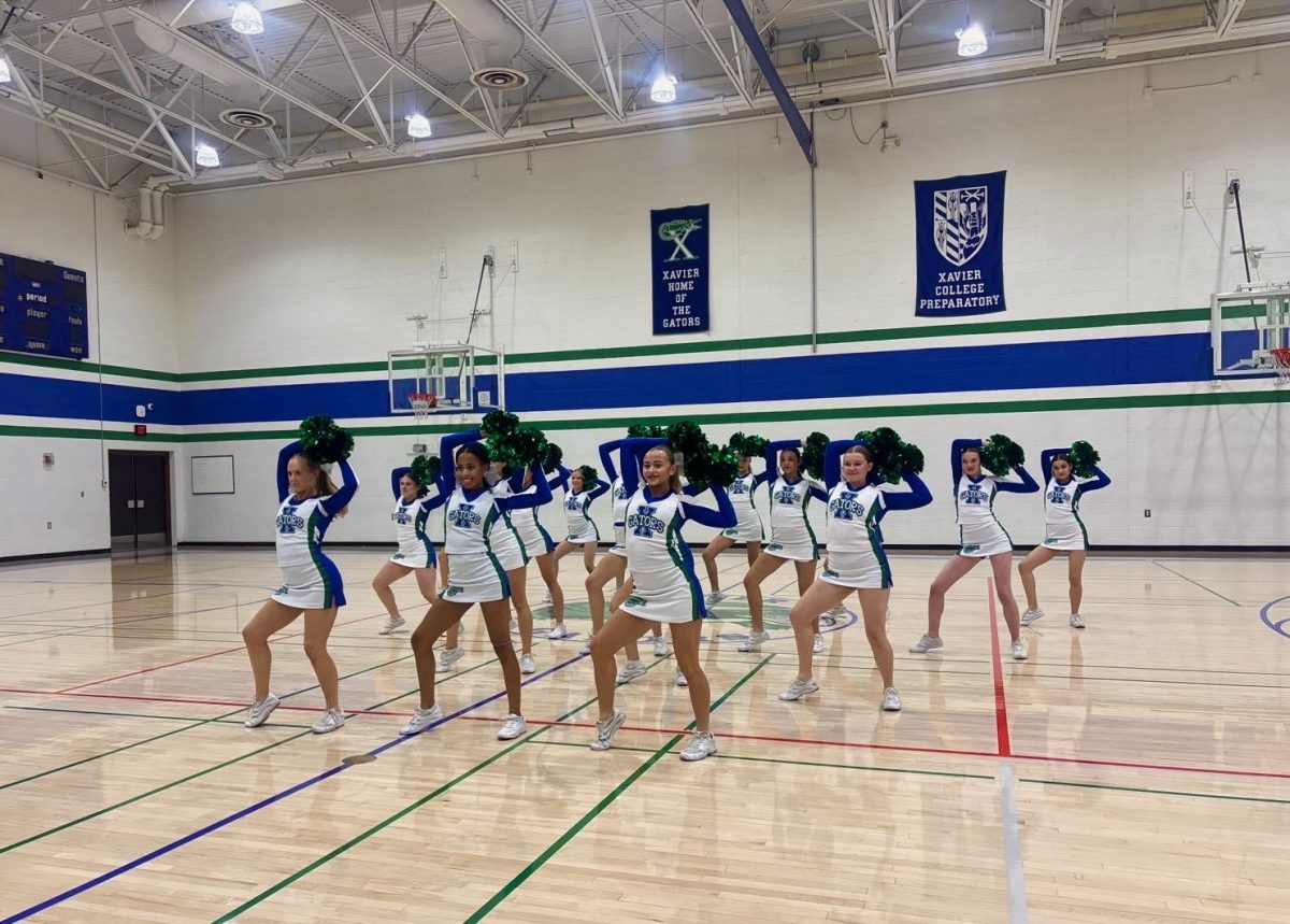 Xavier Gatorline practices before performing a routine during a basketball game's halftime. The performance took place on senior night where three Gatorline seniors were honored for their last season.