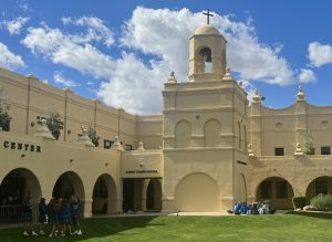 On a sunny weekday, Xavier students relax by the bell tower during lunch. At a Catholic school where faith and academics meet, this grassy common area reflects the ongoing dialogue between religion and science.