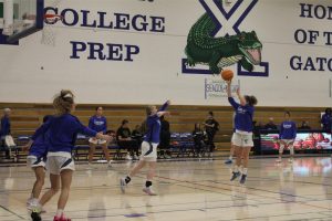 Xavier varsity basketball team takes warmup shots before going against Corona del Sol. The Gators only have two games in the regular season before heading to the playoffs