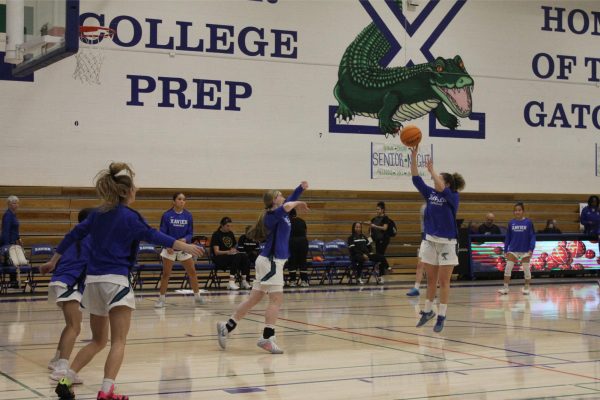 Xavier varsity basketball team takes warmup shots before going against Corona del Sol. The Gators only have two games in the regular season before heading to the playoffs