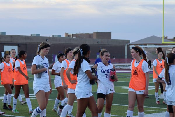 The team takes a water break between overtime and double-overtime. Non-starting players wear orange pennies until they are put in.