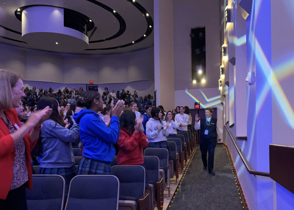 Sister Lynn Winsor walks up to receive her award after working at Xavier for over 50 years. She is cheered on by Xavier students, faculty and alumnae.