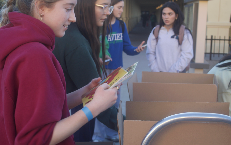 Kendall Hamilton ‘26 drops off books in front of the circle at Xavier. She is donating to Book-a-sweans.