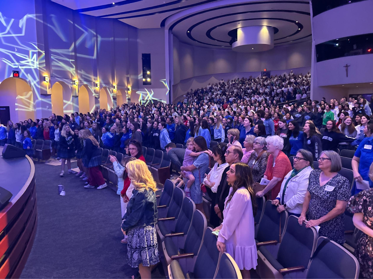 Students and alumnae gather for the annual Traditions Day Assembly on Feb. 24 in the Performing Arts Center at Xavier. Gators are seen singing the Alma Mater that every student will always remember.