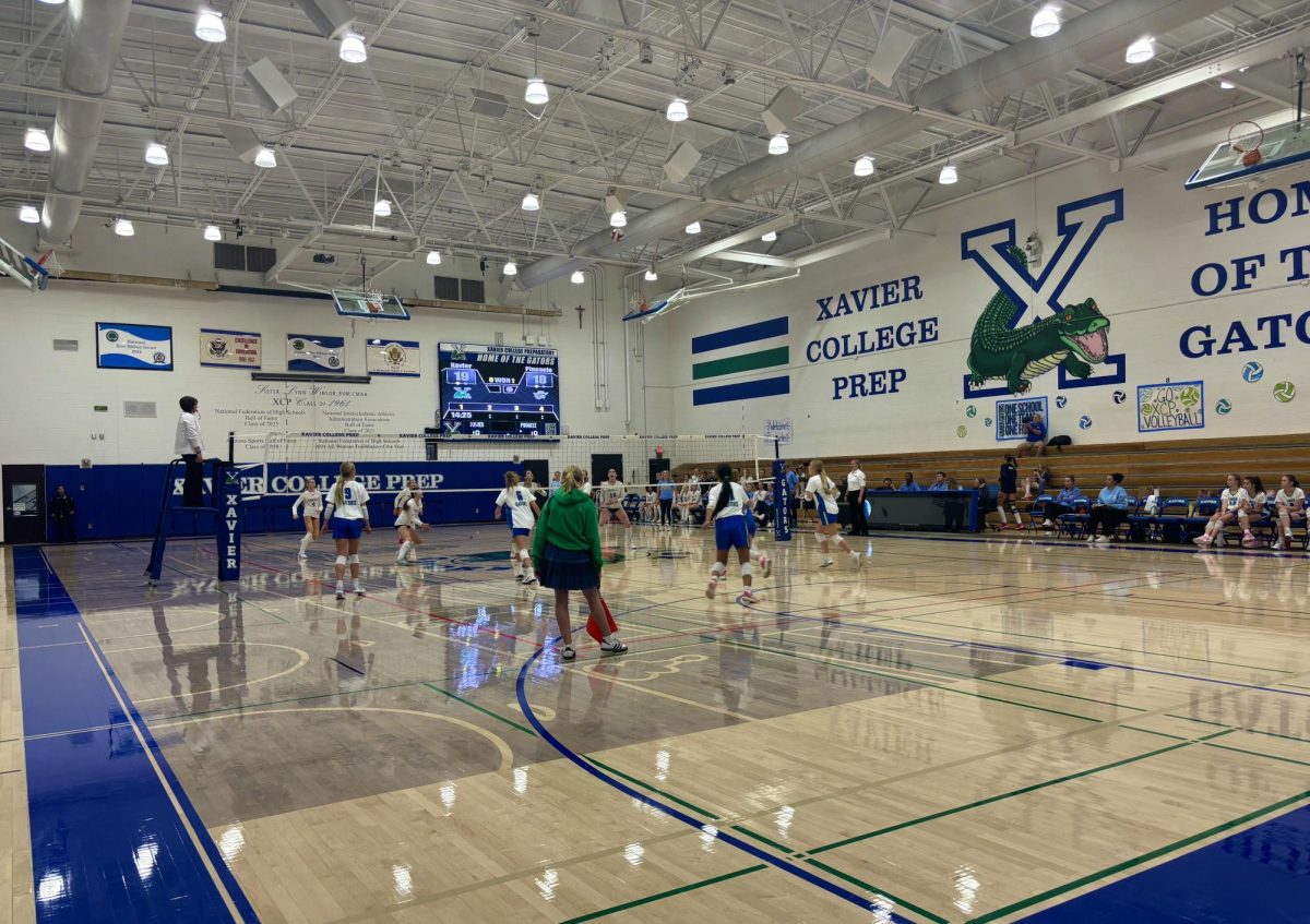 Xavier volleyball competes in a match against Pinnacle. They are working hard throughout the season to develop their young team and players.
