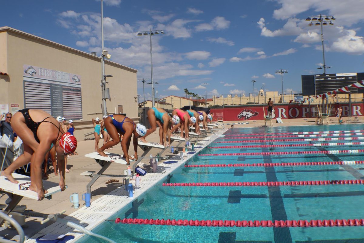 The swim team begins practice at the BCP pool by demonstrating proper form on the track stop block. They do this in preparation for the first swim meet of the season.