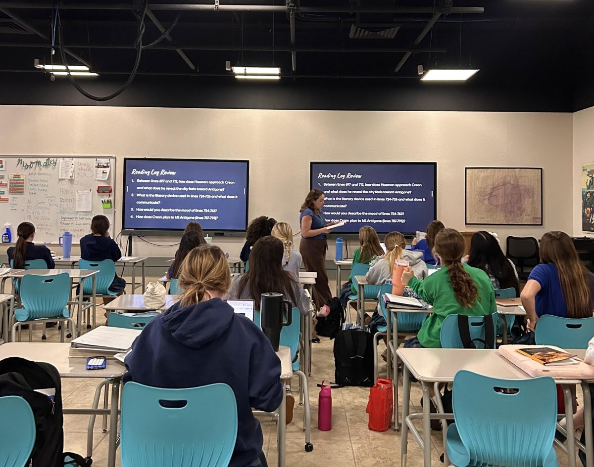 Megan O’Malley joins Xavier’s faculty this year, teaching English and history. She informs her classes about their reading logs.