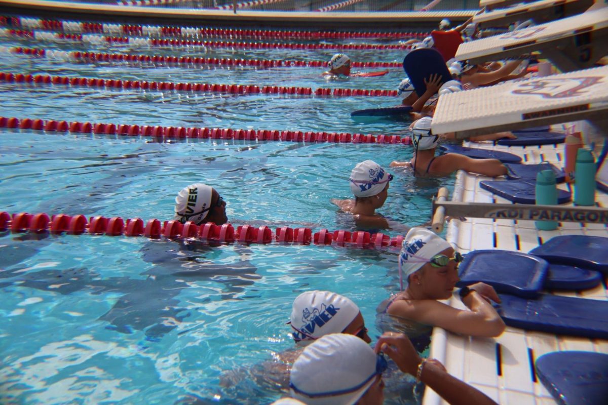 Xavier’s swim & dive team takes a break from practicing at the Brophy pool to talk to each other about the upcoming meet. The team prepares to begin its season strong.