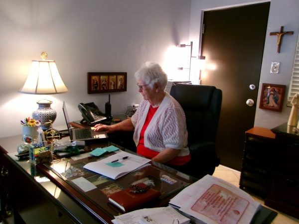 Sister Joan Fitzgerald, president of Xavier College Preparatory, works at her desk. She has dedicated over 60 years to students for great education, and she continues to work for students’ successes. 
