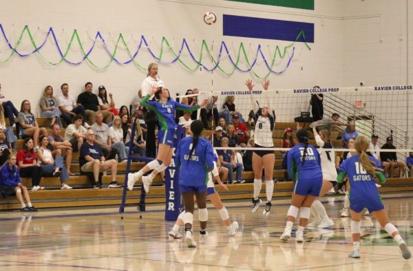 Tessa Larkin ‘27, No. 8, spikes the ball toward Xavier’s opponent, Pinnacle, during her first match. Larkin stepped back onto her home court at Xavier on September 15 after playing with the USA U23 team.
