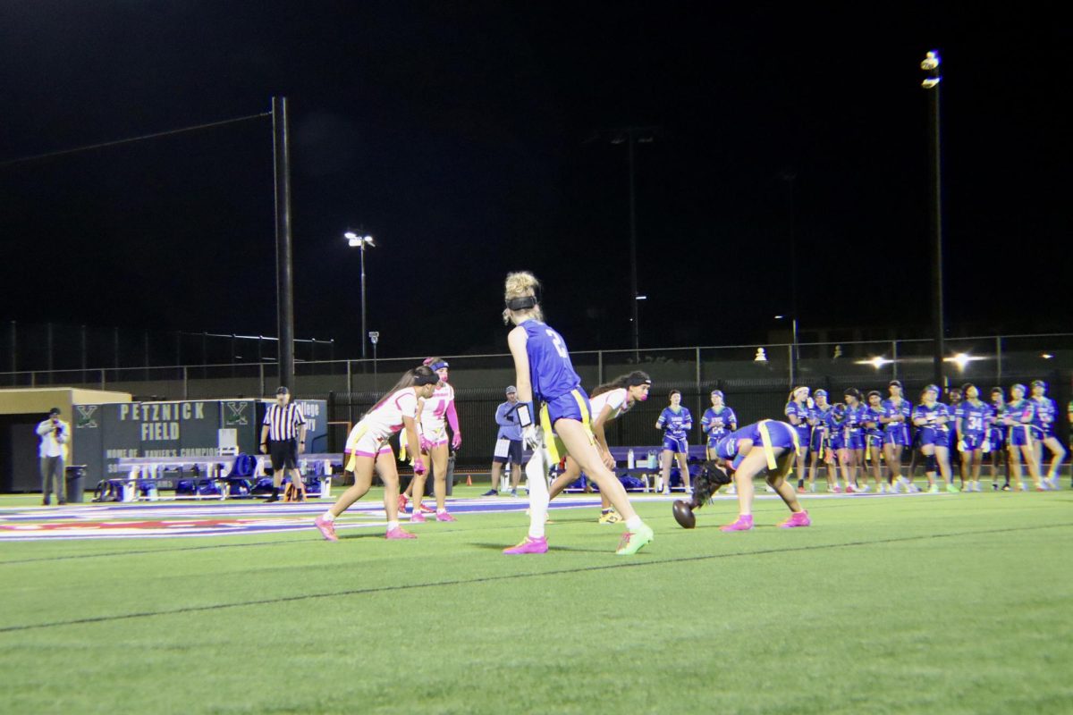 Wide receiver and defensive back Evie Maas ’29 waits for the ball to snap as the team prepares for one of its final plays of the night. Xavier’s flag football team played against Marana High School on Xavier’s Petznick field.